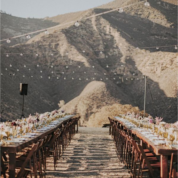 Desert wedding reception with string lights“class=