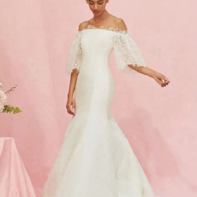 模特在花边合身和闪光，露肩礼服与半袖