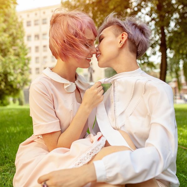 女同性恋情侣在公园接吻的侧视图。