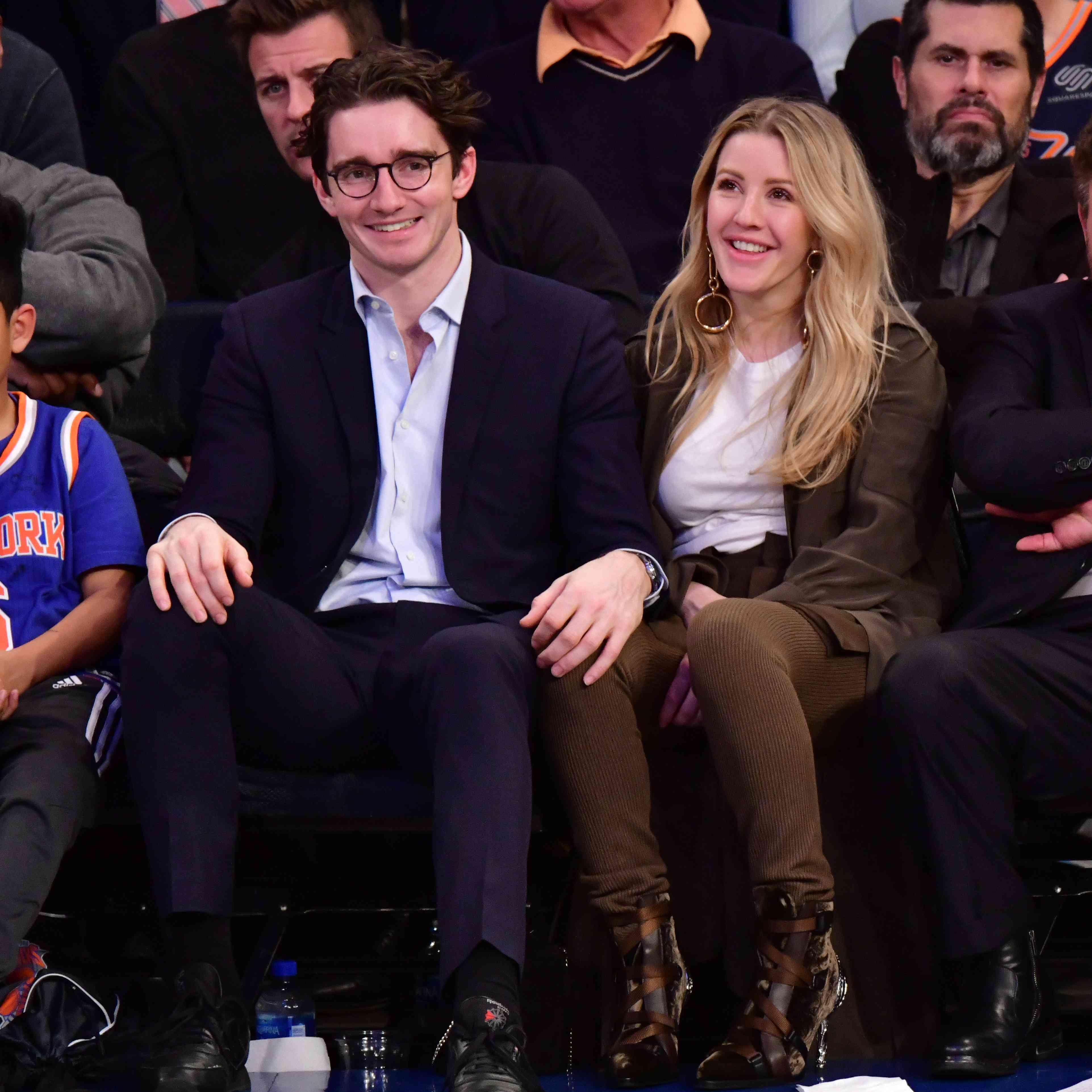 一对夫妇坐在场边和篮球比赛