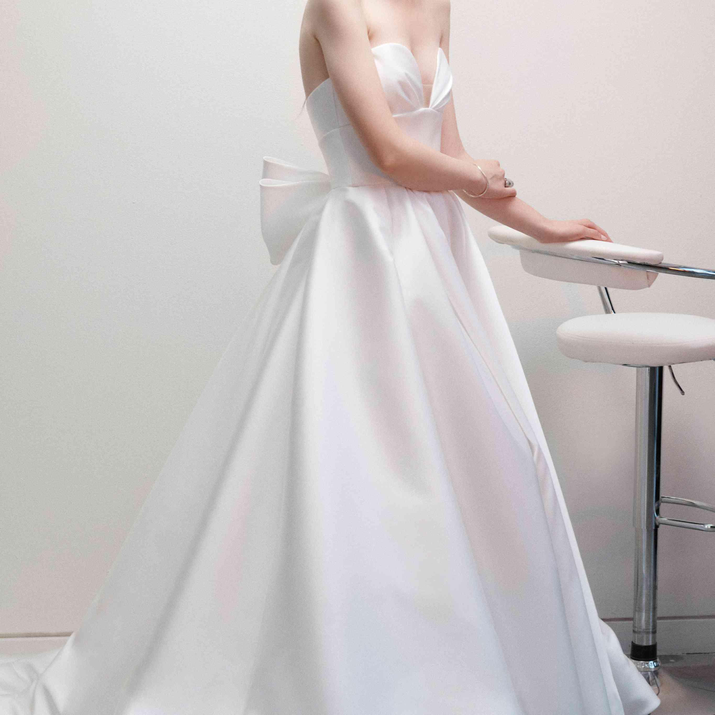 在露肩V领的A-line婚纱礼服在后面的大蝴蝶结型号