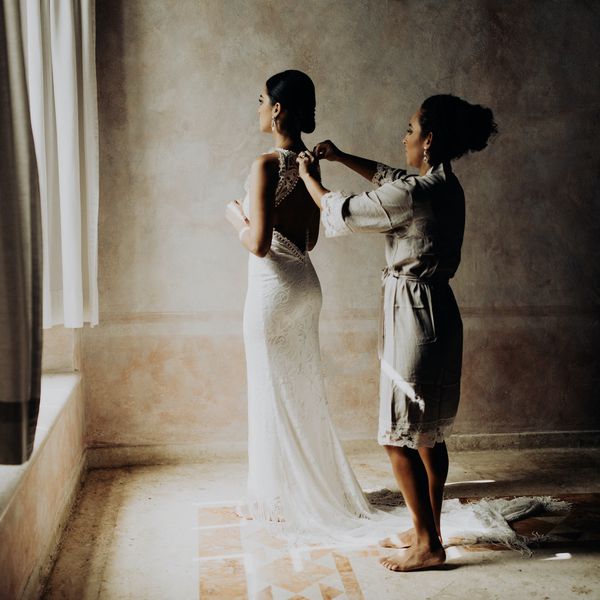 母亲帮助新娘礼服的顶部按钮