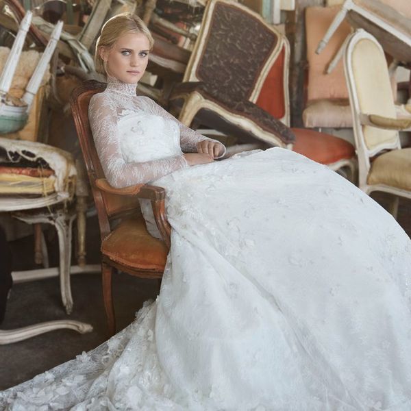 模特坐在长袖模拟蕾丝婚纱的椅子上
