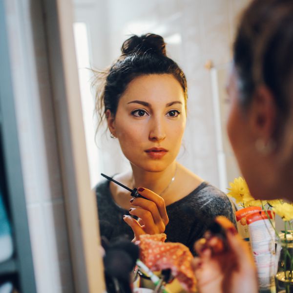 Woman applying eye makeup