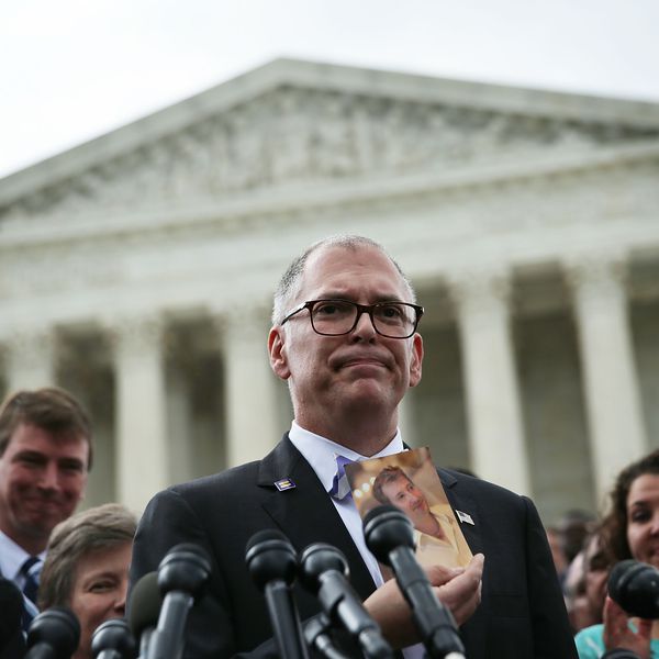 WASHINGTON, DC - JUNE 26: Plaintiff Jim Obergefell holds a photo of his late husband John Arthur as he speaks to members of the media after the U.S. Supreme Court handed down a ruling regarding same-sex marriage June 26, 2015 outside the Supreme Court in Washington, DC. The high court ruled that same-sex couples have the right to marry in all 50 states. (Photo by Alex Wong/Getty Images)“class=
